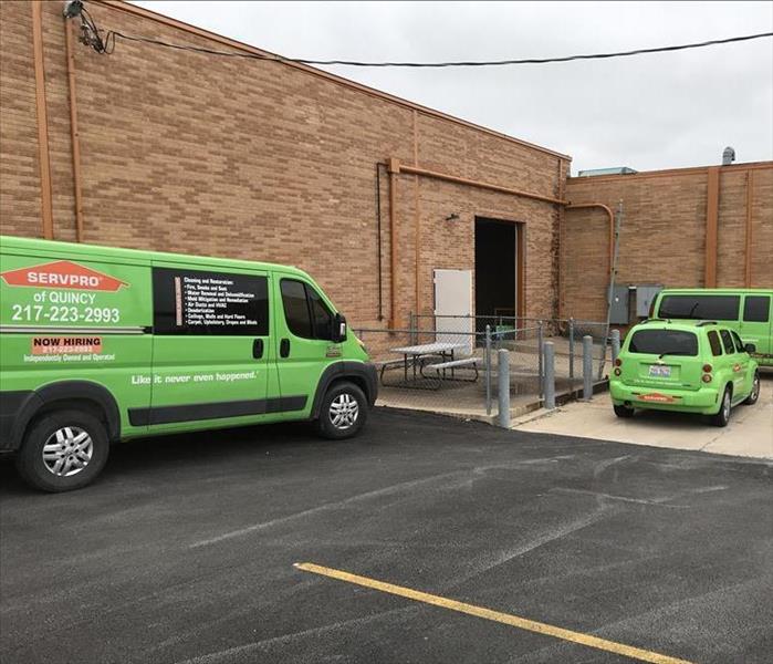 Three SERVPRO vehicles parked outside a Commercial Building.